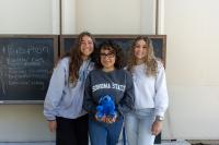 Students standing in front of Darwin Hall chalkboard