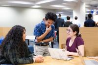 Students chatting in the library